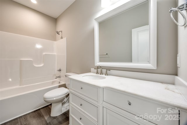 full bathroom featuring shower / washtub combination, toilet, wood-type flooring, and vanity