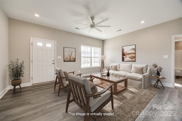 living room with dark wood-type flooring and ceiling fan