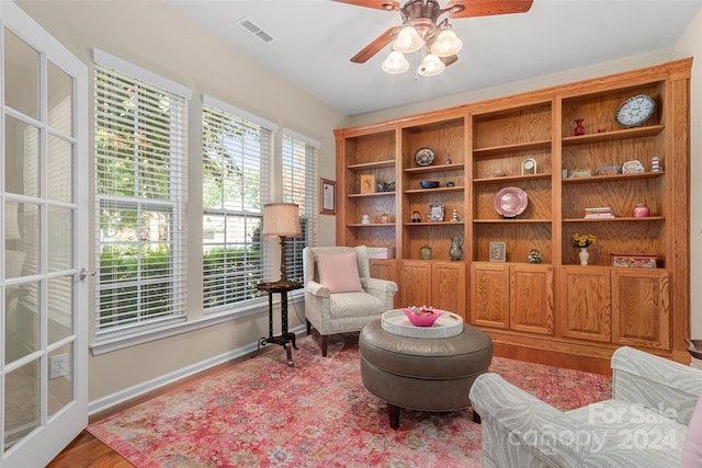 living area featuring ceiling fan and wood-type flooring