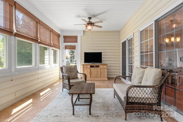 sunroom / solarium featuring ceiling fan