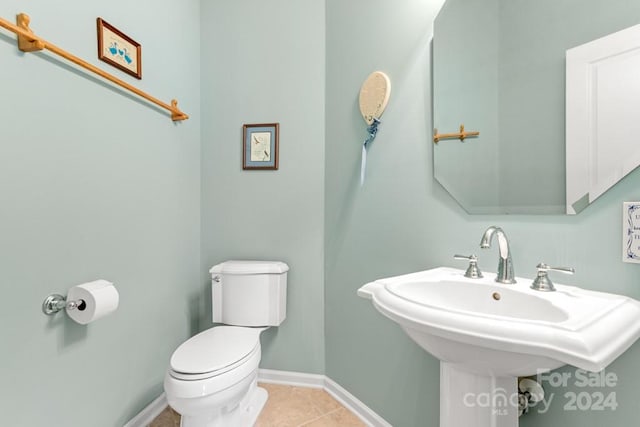 bathroom featuring tile patterned flooring, toilet, and sink