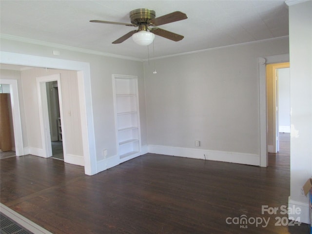 spare room with dark wood-type flooring, ceiling fan, and ornamental molding