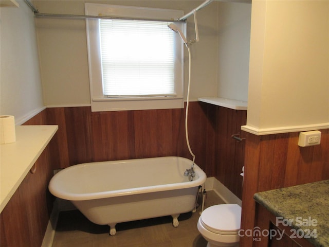 full bathroom featuring shower / bathing tub combination, vanity, toilet, and wood walls