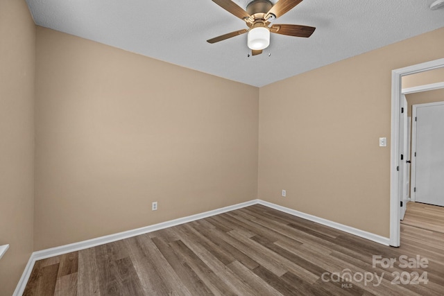 unfurnished room featuring a ceiling fan, baseboards, and wood finished floors