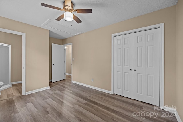 unfurnished bedroom featuring a closet, baseboards, and wood finished floors