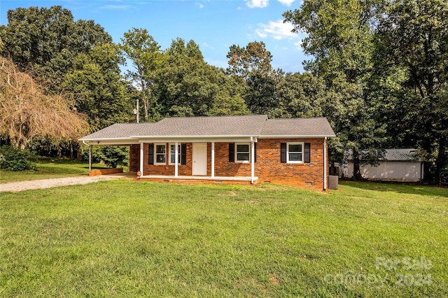 ranch-style house with covered porch and a front yard