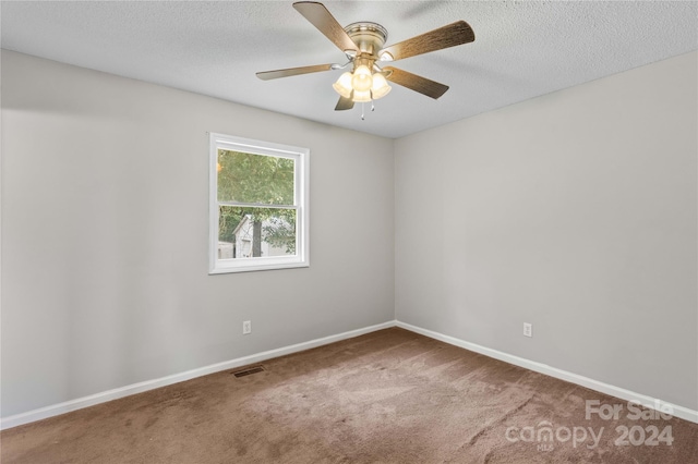 carpeted empty room featuring a textured ceiling and ceiling fan