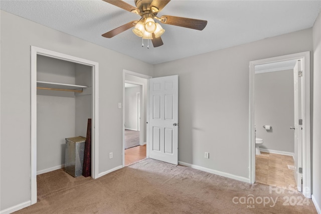 unfurnished bedroom with a closet, ceiling fan, and light colored carpet