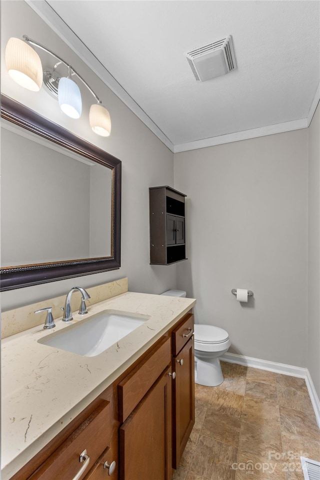 bathroom featuring crown molding, vanity, and toilet