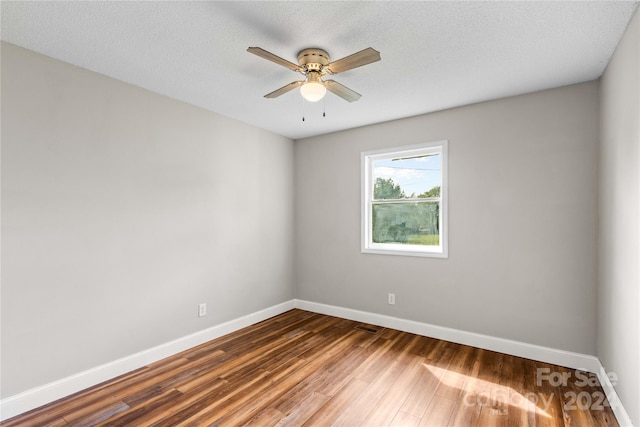 spare room with ceiling fan, hardwood / wood-style flooring, and a textured ceiling