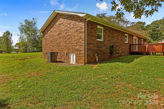 view of home's exterior with a lawn, a wooden deck, and central air condition unit