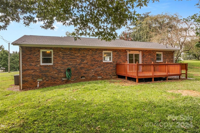 back of house with cooling unit, a lawn, and a wooden deck