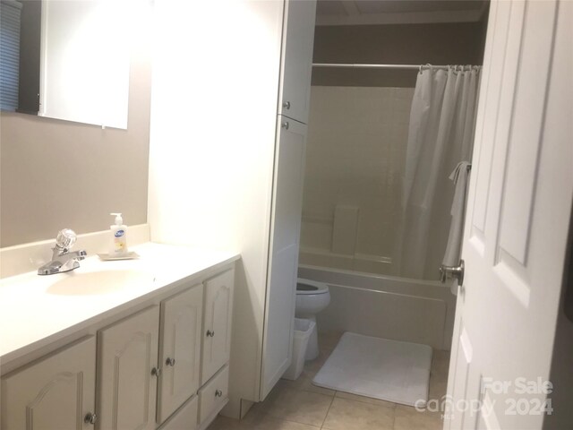 full bathroom with vanity, toilet, shower / tub combo with curtain, and tile patterned floors