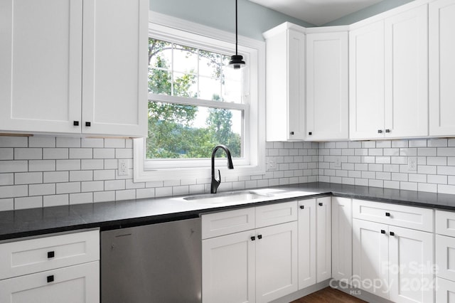 kitchen with sink, dishwasher, hanging light fixtures, white cabinets, and decorative backsplash