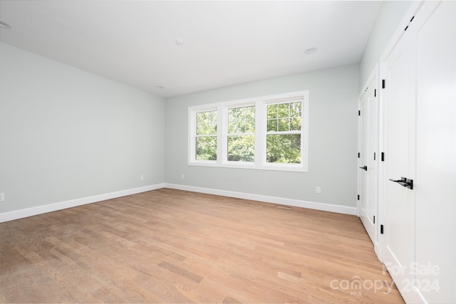 spare room with light hardwood / wood-style flooring