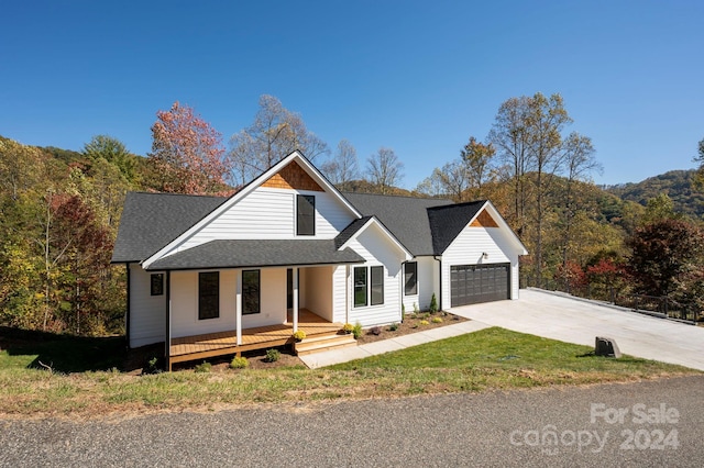 view of front of property featuring a porch and a garage