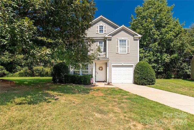 view of front of home featuring a garage and a front lawn