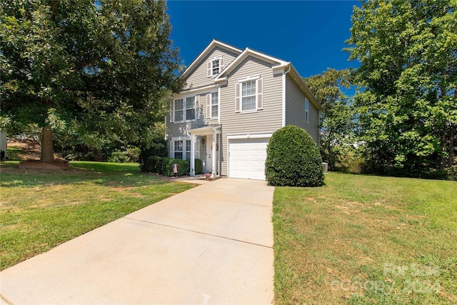 front facade featuring a garage and a front yard