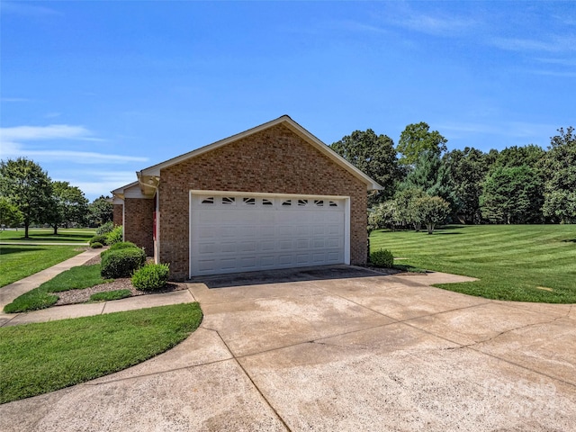 garage featuring a lawn