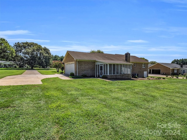 back of property with a yard and a garage