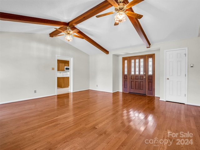 entrance foyer featuring light hardwood / wood-style flooring, ceiling fan, and vaulted ceiling with beams