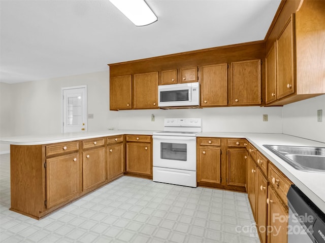 kitchen featuring white appliances and kitchen peninsula