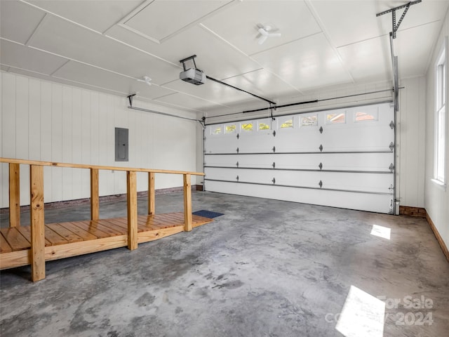 garage featuring electric panel and a garage door opener