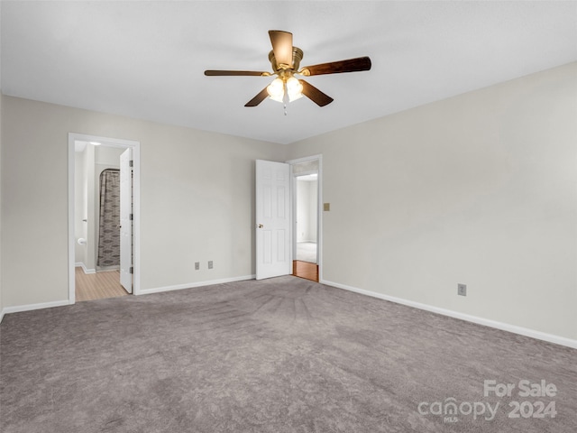 interior space featuring carpet flooring, ceiling fan, and connected bathroom