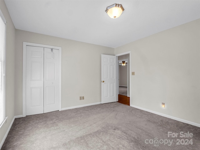 unfurnished bedroom with carpet and a closet