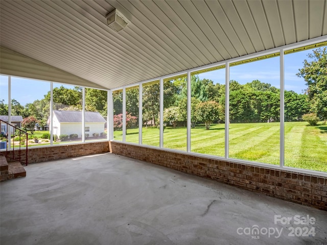 unfurnished sunroom with lofted ceiling