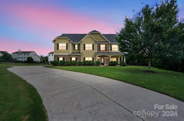 view of front of home featuring a yard and a porch