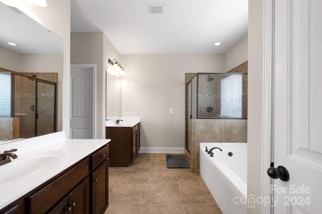 bathroom featuring shower with separate bathtub, vanity, and tile patterned floors