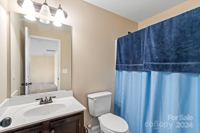 bathroom featuring vanity and toilet