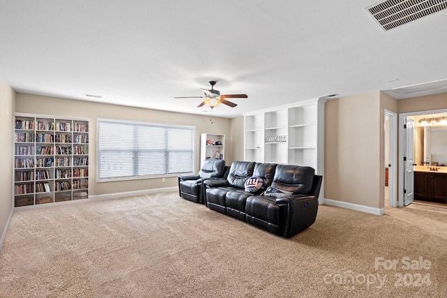 carpeted living room with ceiling fan