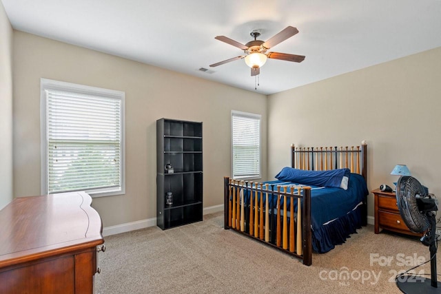 bedroom with ceiling fan and light colored carpet