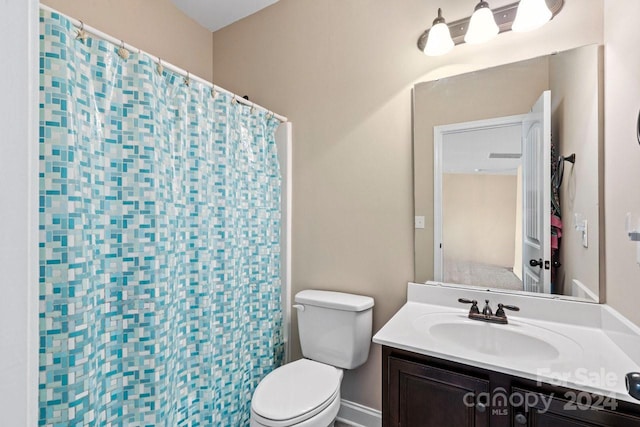 bathroom with vanity, toilet, and a shower with shower curtain