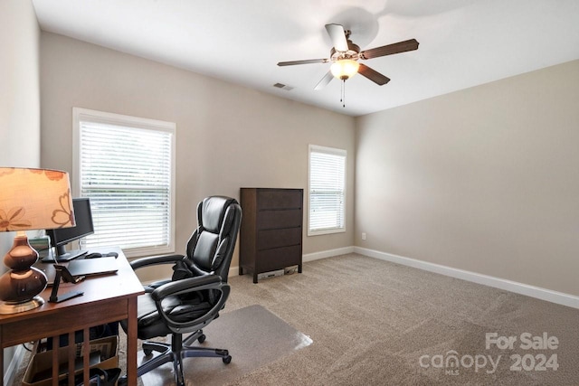 carpeted office space with ceiling fan