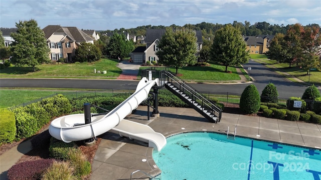 view of pool featuring a water slide