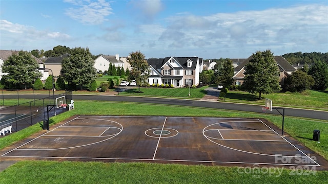 view of basketball court with a yard