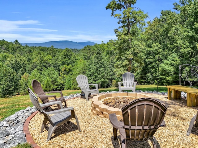 view of yard featuring a mountain view and a fire pit