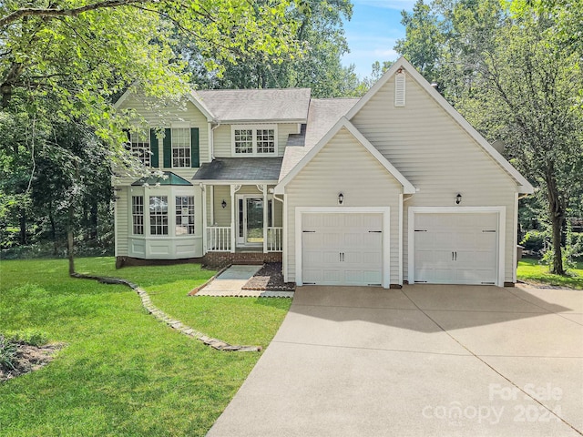 view of property with a garage and a front lawn