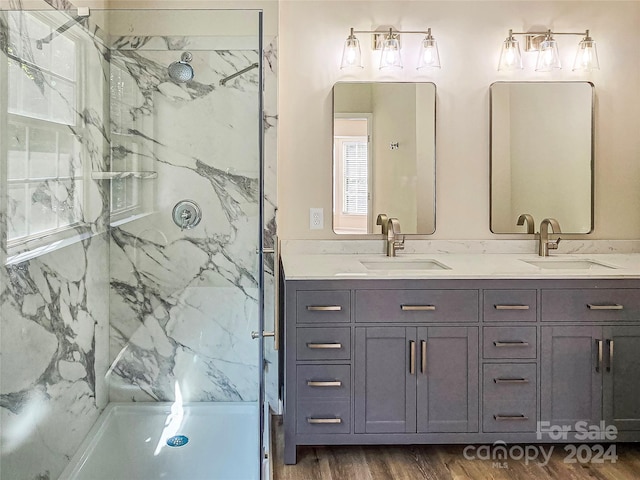 bathroom with vanity, wood-type flooring, and tiled shower