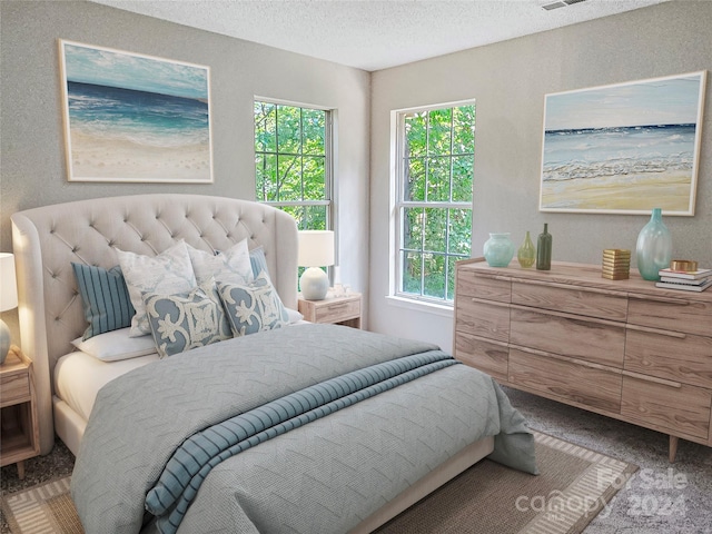 bedroom with carpet flooring and a textured ceiling