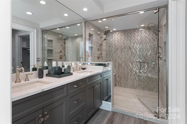 bathroom with vanity, hardwood / wood-style flooring, and walk in shower