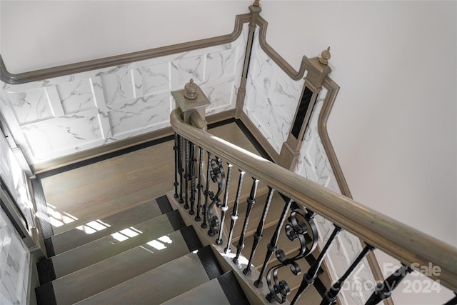 stairway featuring wood-type flooring