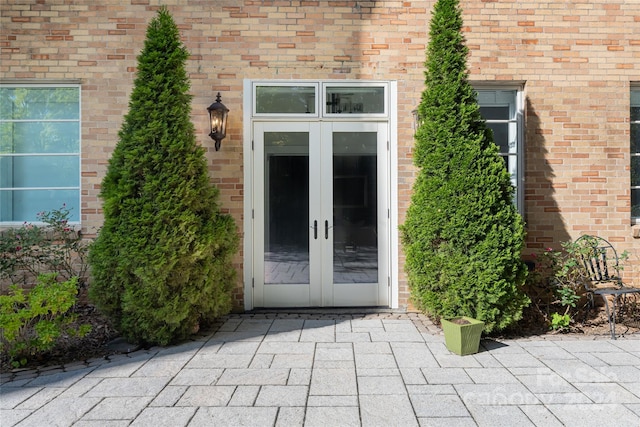 view of exterior entry featuring a patio and french doors