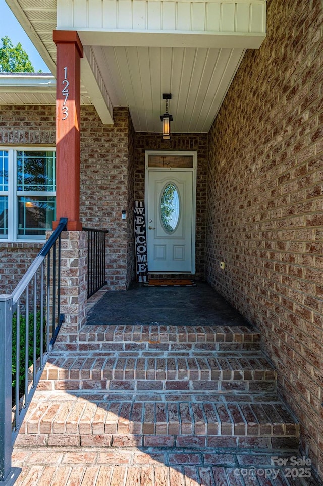 view of exterior entry with covered porch