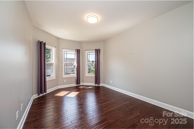 unfurnished room featuring dark wood-type flooring