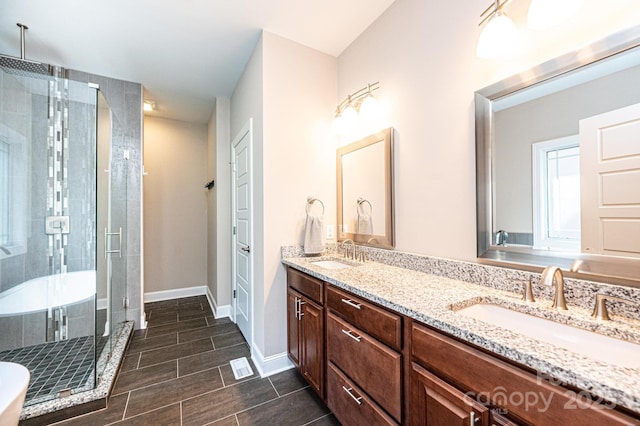 bathroom with a shower with door and vanity