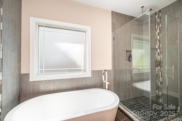 bathroom with tile patterned floors and separate shower and tub